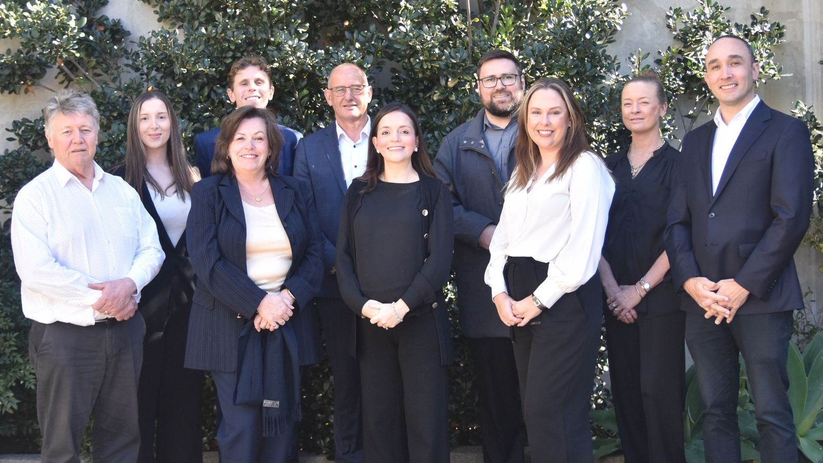 The Cashflow Financial team photographed together outside the office